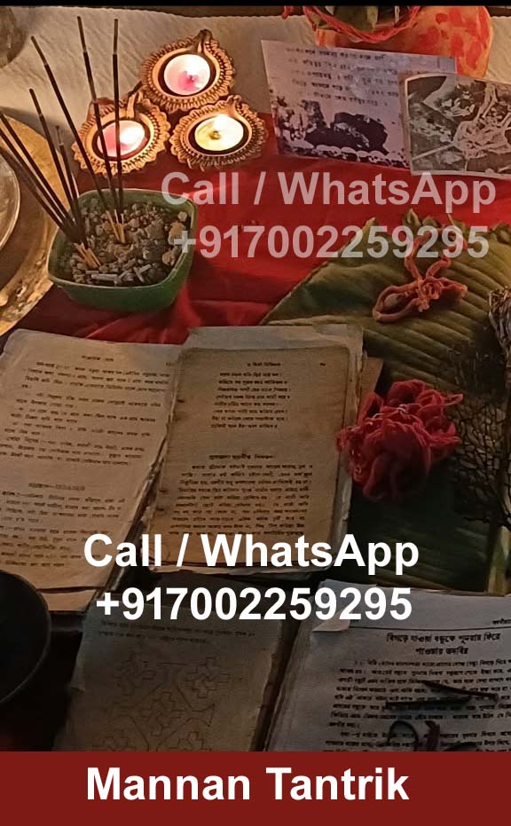 Manuscripts, incense and lit lamps arranged in the consultation space of Mannan Tantrik